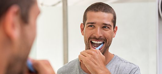 happy man brushing teeth