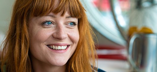smiling girl with red hair and blue eyes