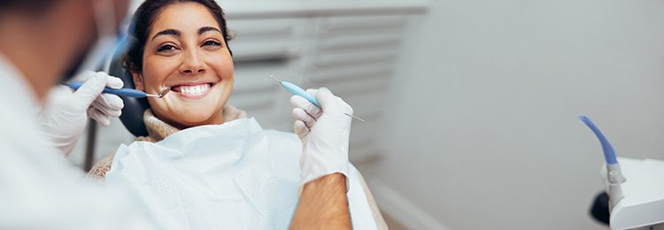 Woman getting her dental routine procedure done by a dentist